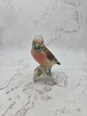 a figurine of a bird sitting on top of a table