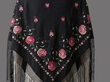 a black shawl with pink roses and fringes on it
