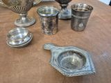 a table with a lot of silver items on it