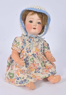 a doll that is wearing a dress and a hat