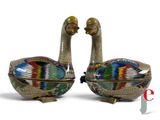 pair of colorfully painted ducks sitting next to each other on a white surface