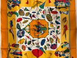 a yellow scarf with colorful birds and flowers on it