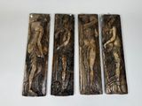 four wooden plaques depicting a woman and two men
