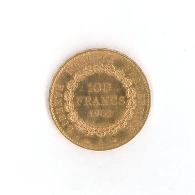 a gold coin on a white surface with a white background