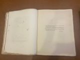 an open book on a table with a pen on it