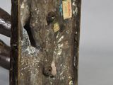 a small bronze sculpture of a horse with a hole in it ' s face