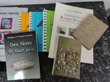 several books are sitting on a table next to each other
