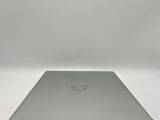 an open laptop computer sitting on top of a white surface