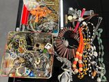 a tray of assorted jewelry on a table