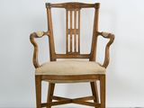 an image of a wooden chair with beige upholstered seat