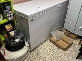 a refrigerator and a freezer in a small room