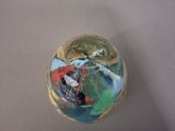 a glass ball with a picture of a boat inside of it