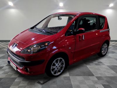 a picture of a red car parked on a checkered floor