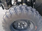 a close up of the front wheel of a four wheeler atv