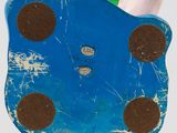 a blue toy with brown spots on it sitting on a table