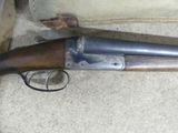 a gun that is laying on the ground next to a wall