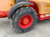 a tractor that is parked on the side of the road