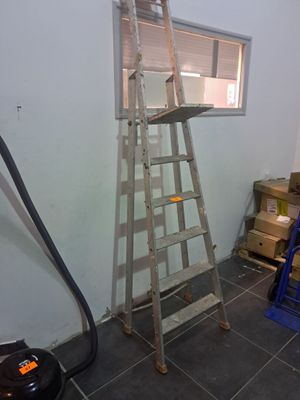 a ladder that is leaning against a wall in a room