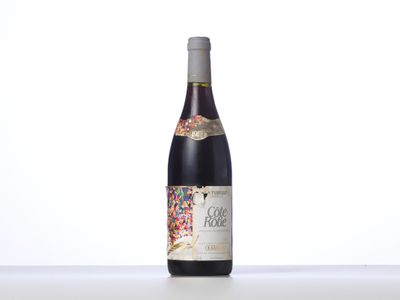 a bottle of wine sitting on top of a white table
