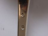 a silver spoon with a silver handle on a white table