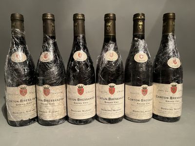 six bottles of wine are lined up in a row on a table