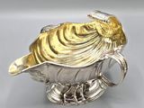 an antique silver and gold plated sugar dish with a bird on top