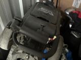 a suitcase sitting on top of a chair next to a pile of luggage