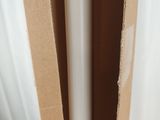 a cardboard box sitting on top of a table next to a window