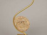 gold plated metal sculpture of a bird on a spiral base
