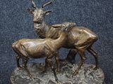 bronze sculpture of a stag and a baby stag on a base