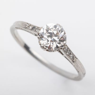 a close up of a diamond engagement ring on a white background