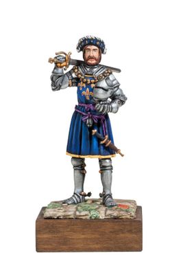 statue of a man dressed in armor holding a sword and a shield