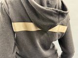 a woman that is wearing a hoodie with a tape on it