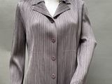 an image of a mannequin wearing a gray jacket and black pants