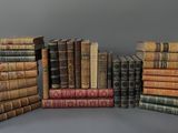 plusieurs vieux livres empilés les uns sur les autres sur une surface grise