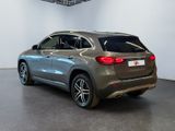 the rear of a silver mercedes suv parked in a showroom