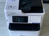a white printer sitting on top of a stack of black and white printers