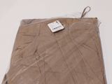 the brown pants are wrapped in plastic and ready to be worn