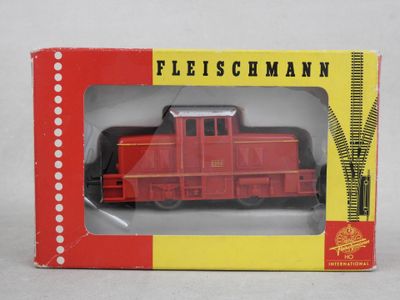 a box with a toy train in it on a white surface