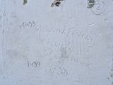 a cement plaque with writing on it on the side of a building