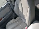 a seat in the back of a car with a cup holder on it