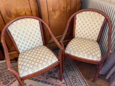 two chairs sitting next to each other on a rug