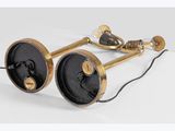 a pair of black and gold lamps on a white surface