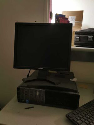 a desktop computer sitting on top of a desk next to a keyboard and mouse