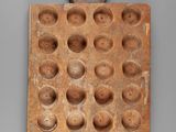 an image of a wooden block with a face on it
