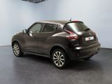 the back end of a dark colored nissan juke parked in a room