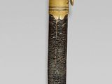 an image of a gold and black sword with a bird on it