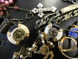 many different types of jewelry on a black table