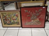 three framed pictures of flowers and birds on a table in a kitchen