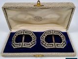 pair of silver and crystal cuff earrings in a velvet case